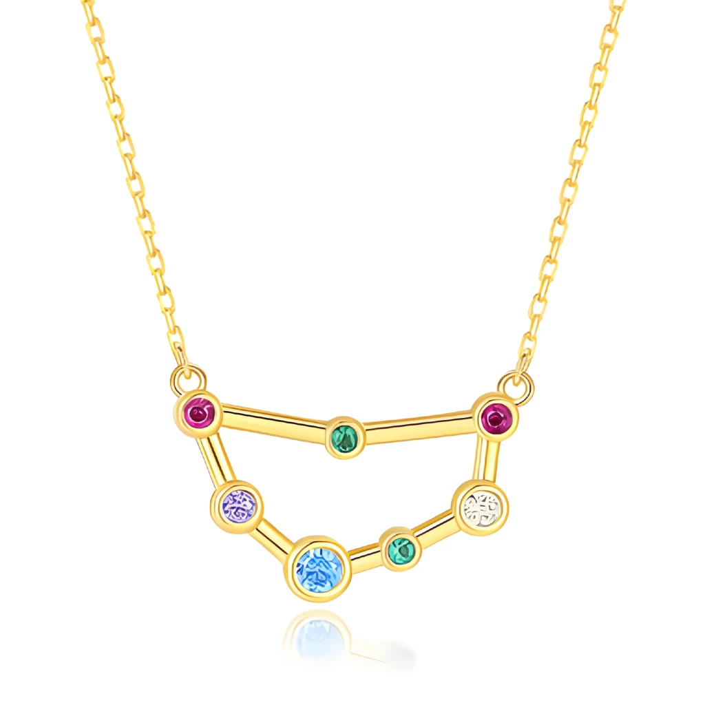 Gold necklace with a zodiac sign pendant featuring colorful gemstones on a white background