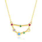 Gold necklace with a zodiac sign pendant featuring colorful gemstones on a white background