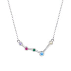 Silver necklace with a zodiac sign pendant featuring colorful gemstones on a white background
