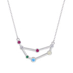 Silver necklace with a zodiac sign pendant featuring colorful gemstones on a white background