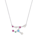 Silver necklace with a zodiac sign pendant featuring colorful gemstones on a white background