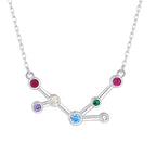 Silver necklace with a zodiac sign pendant featuring colorful gemstones on a white background