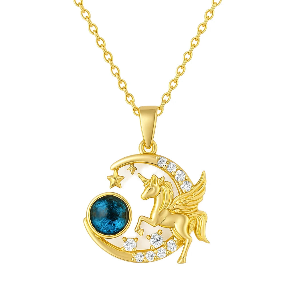 Gold unicorn pendant with blue gemstone on a white background
