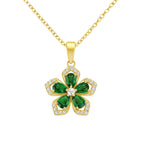 Gold necklace with a green five-leaf clover pendant on a white background