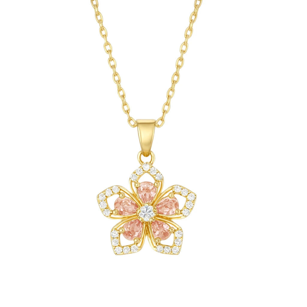 Gold necklace with a pink flower pendant on a white background