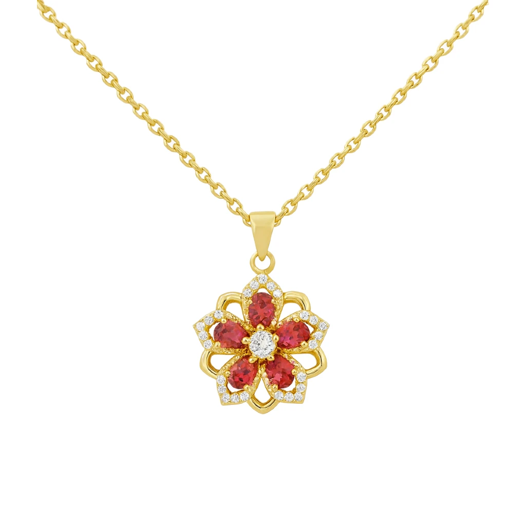 Gold necklace with a red gemstone pendant on a white background