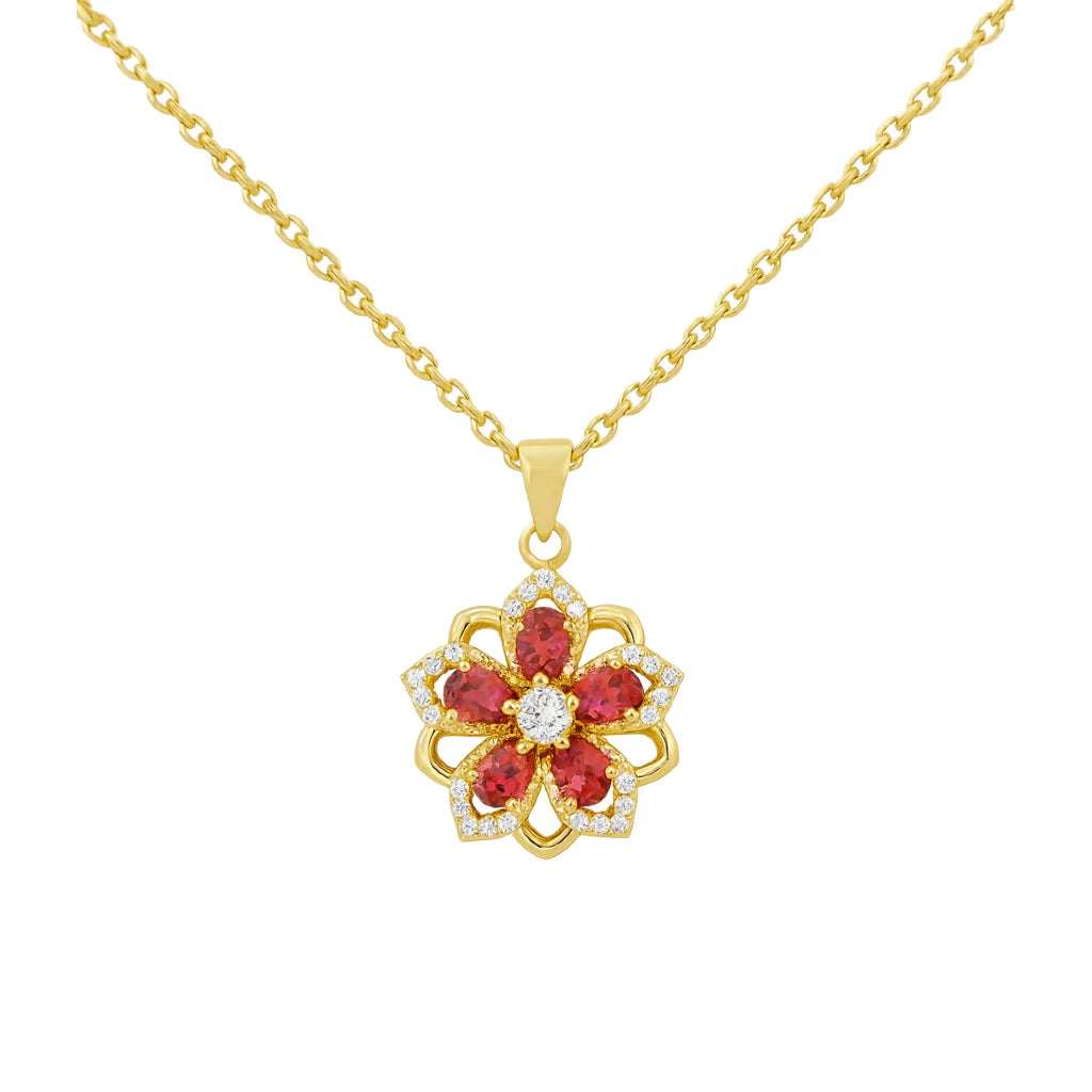 Gold necklace with a red gemstone pendant on a white background