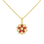 Gold necklace with a red gemstone pendant on a white background
