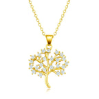 Gold tree-shaped pendant necklace with clear stones on a white background