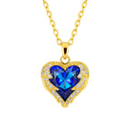 Gold necklace with a blue heart-shaped pendant on a white background