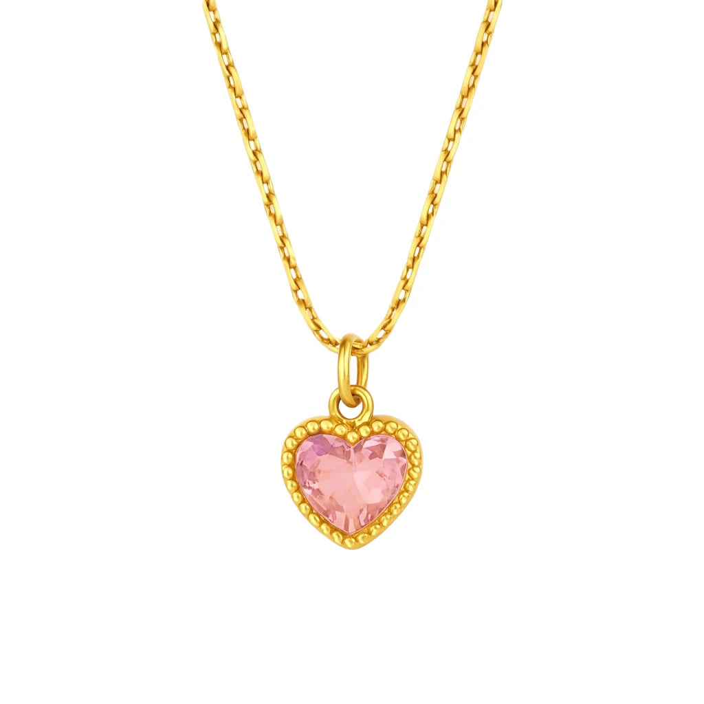 Gold necklace with a pink heart-shaped pendant on a white background