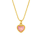 Gold necklace with a pink heart-shaped pendant on a white background