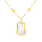 Gold necklace with a rectangular pearl pendant on a white background