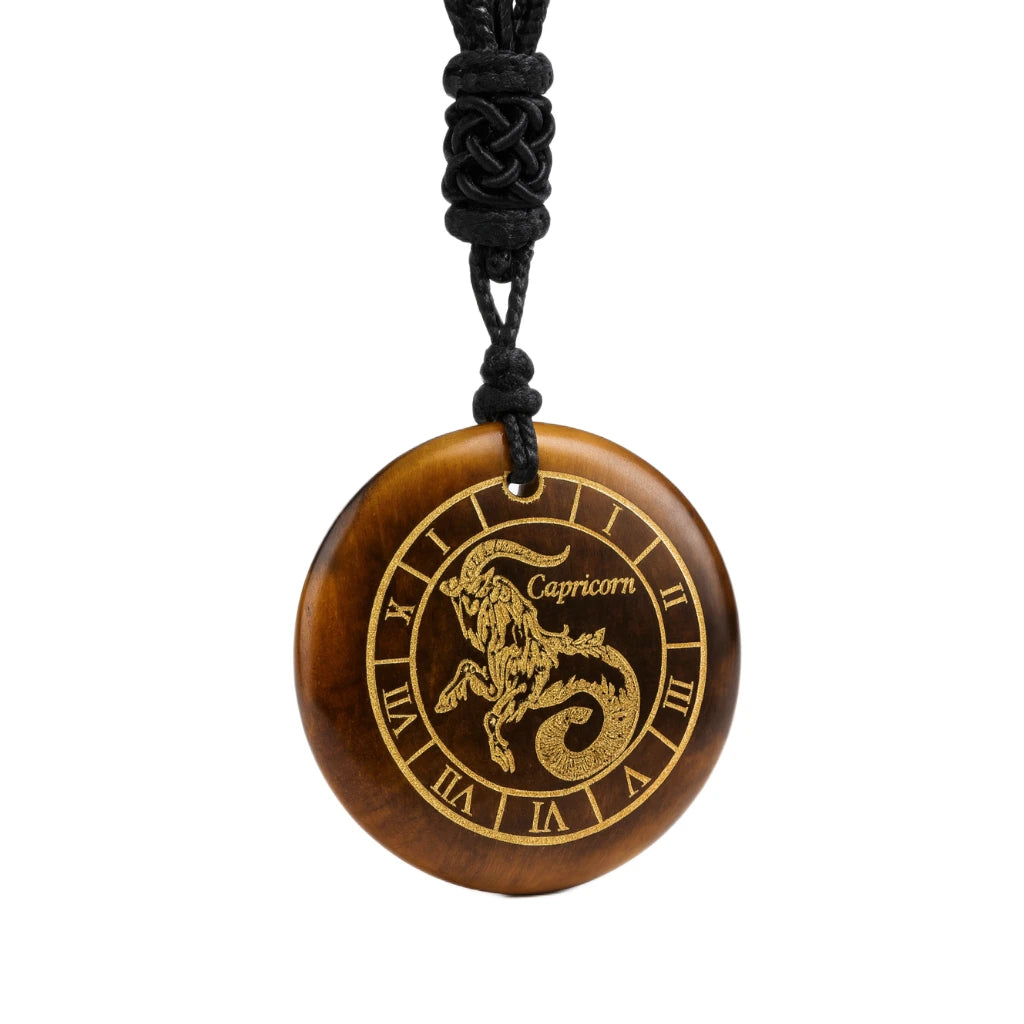 Brown pendant with Capricorn zodiac symbol on a black cord against a white background