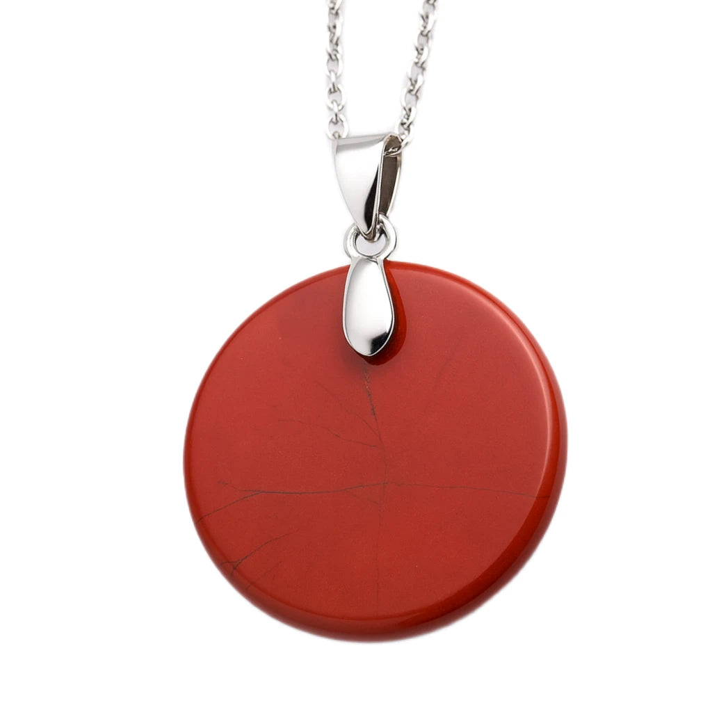 Red circular pendant on a silver chain against a white background
