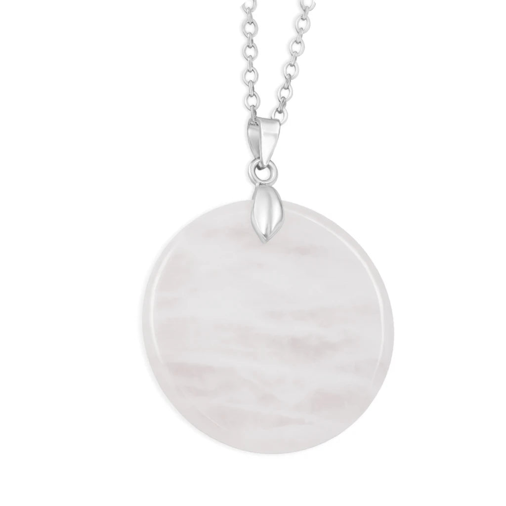 Round white stone pendant on a silver chain against a white background